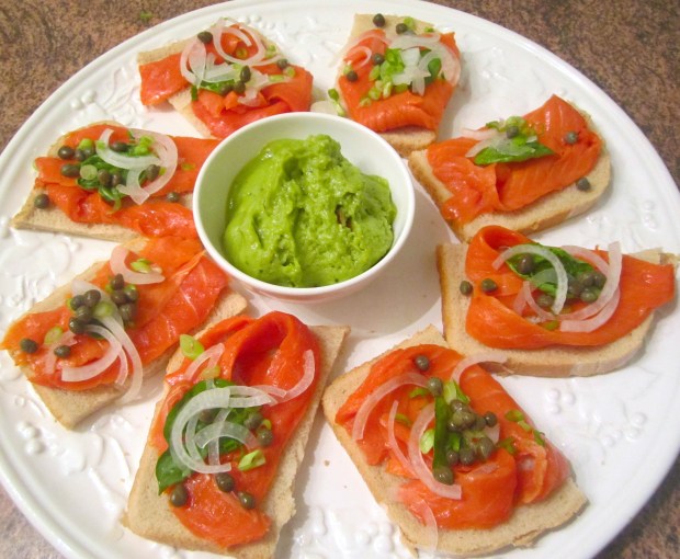 Smoked salmon, sour dough bread, garlic butter,  sliced onion, capers, basil leaves, guacamole.