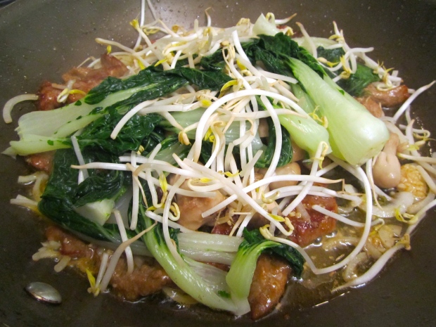 Add blanched bok choy and bean sprouts, saute until heated through. 