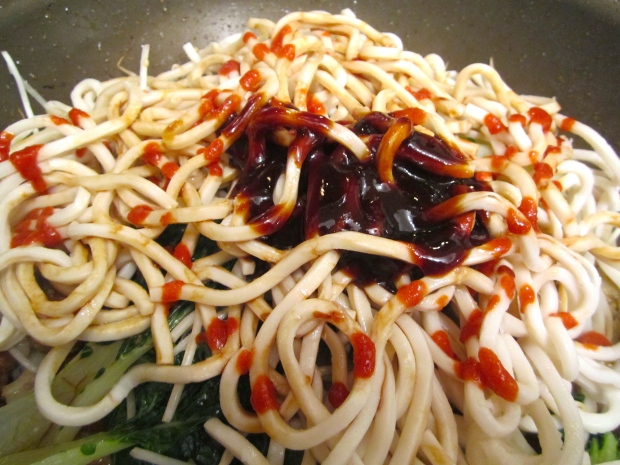 Add freshly cooked and drained udon noodles, hoi sin sauce, soy sauce, sriracha and maggi seasoning. mix well. 