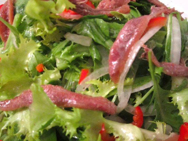frissee, arugula, onions, chilies and anchovies in dijon vinaigrette