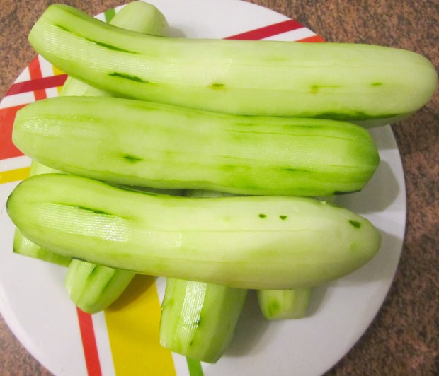 peel cucumbers, slice thin
