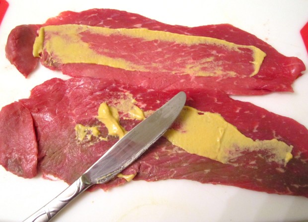 season thinly slicedbeef cutlets with kosher salt, spread with dijon mustard