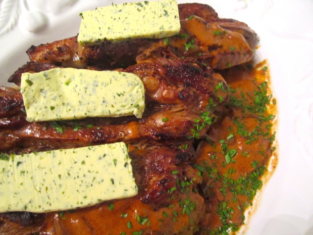 to plate, arrange veal on top of bread, spoon sauce over top, crown wiyh garlic/herb butter