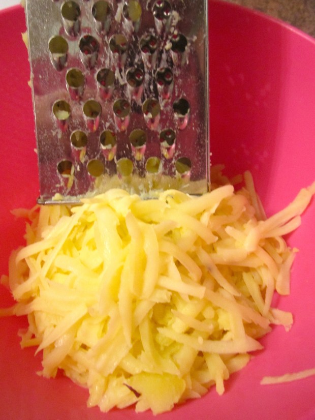 grate half-cooked potatoes into long shredds