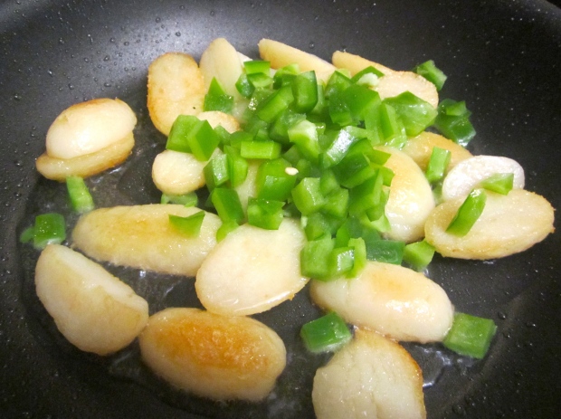 meanwhile, saute cooked ptatoes in garlic oil until golden, add diced peppers, saute another minute