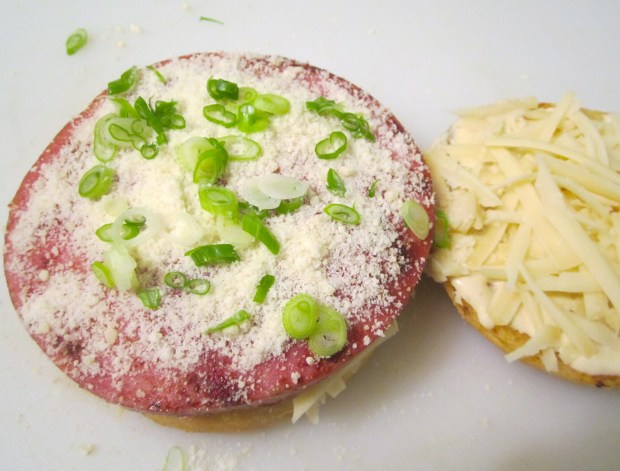 top first bread with ham, sprinkle with grated cheese and scallions or herbs of your choice