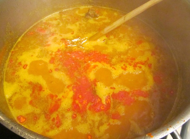 add lots of garlic paste, a handful of rice, a good amount of turmeric, a few anatto seeds, salt and pepper and bring to a simmer