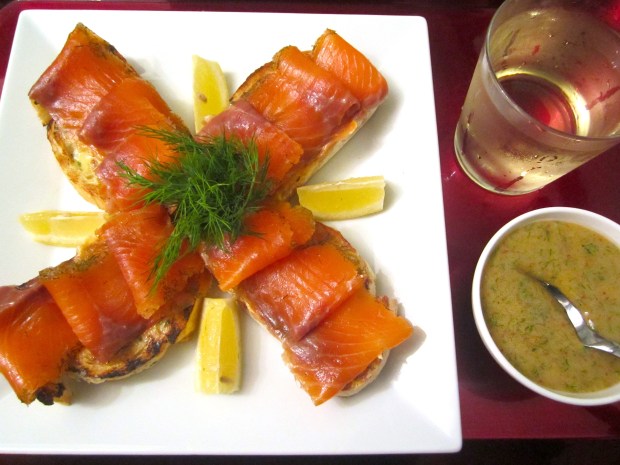 top with thinly sliced gravlax, serve with dill/ mustard sauce, lemon slices and chilled white wine