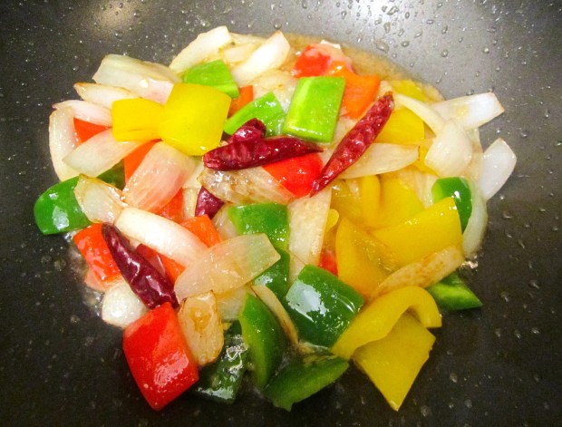 add peppers and scallions, saute for two minutes, add garlic paste and grated ginger, saute until fragrant, remove, reserve