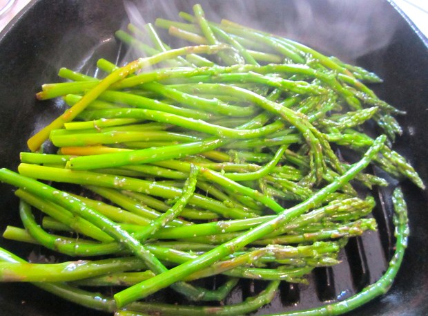 season blanched green asparagus with kosher salt and cayenne pepper, coat in garlic oil, grill until heated through