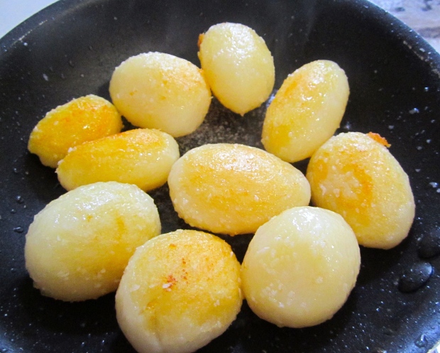 saute small blanched potatoes in garlic oil until golden, season with kosher salt and cayenne pepper