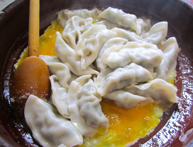 add freshly boiled, drained dumplings (if using leftovers, saute after onions before adding the garlic paste