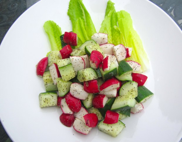 plate salad on vinaigrette dressed romaine