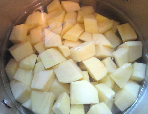 Cook diced potatoes in saltwater until tender, drain, mash