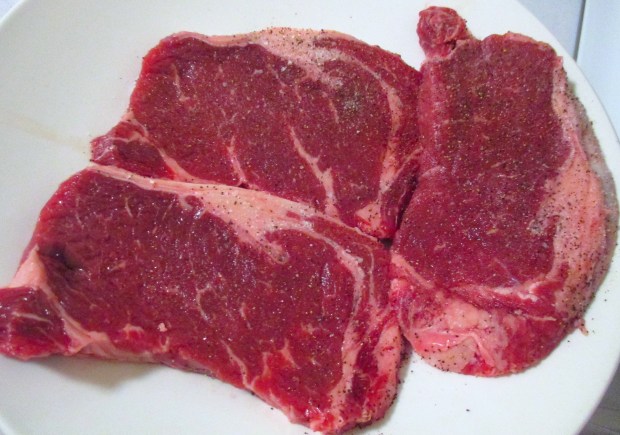 meanwhile, season steaks with kosher salt and fresh ground black pepper