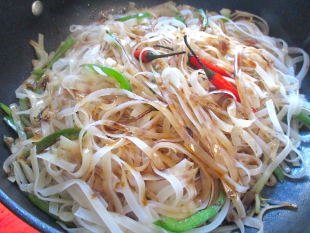 add rice noodles which you had soaked in warm water for 10 minutes then drained, add a small amount of soy sauce and water, cook until liquid has evaporated