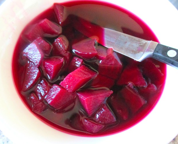 simmer cleaned red beets in salted water until cooked, reserve cooking liquid,peel and dice beets
