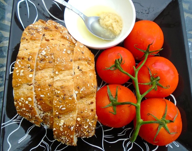 sour dough bread, vine-ripened tomatoes, garlic-confit paste in olive oil