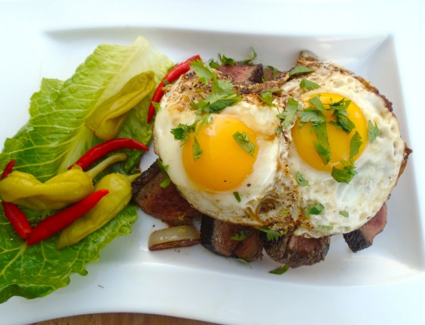 top caramelized onions with fried eggs